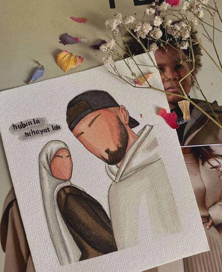 A hand-drawn faceless portrait of a Muslim couple, the woman wearing a white hijab and brown outfit, and the man wearing a white hoodie and black cap. The artwork is placed on a magazine with dried flowers and petals around it. The text on the artwork says 'hubin la nihayat lah